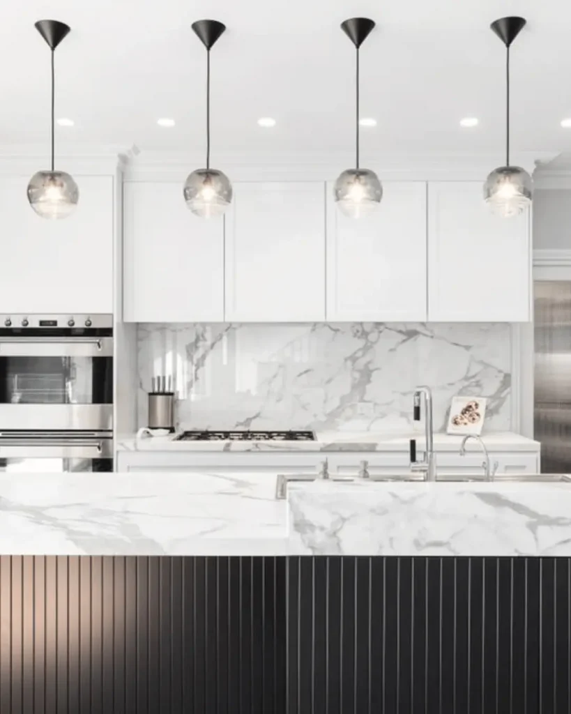Luxurious kitchen renovation with white cabinetry, marble benchtops, and pendant lighting – Melbourne