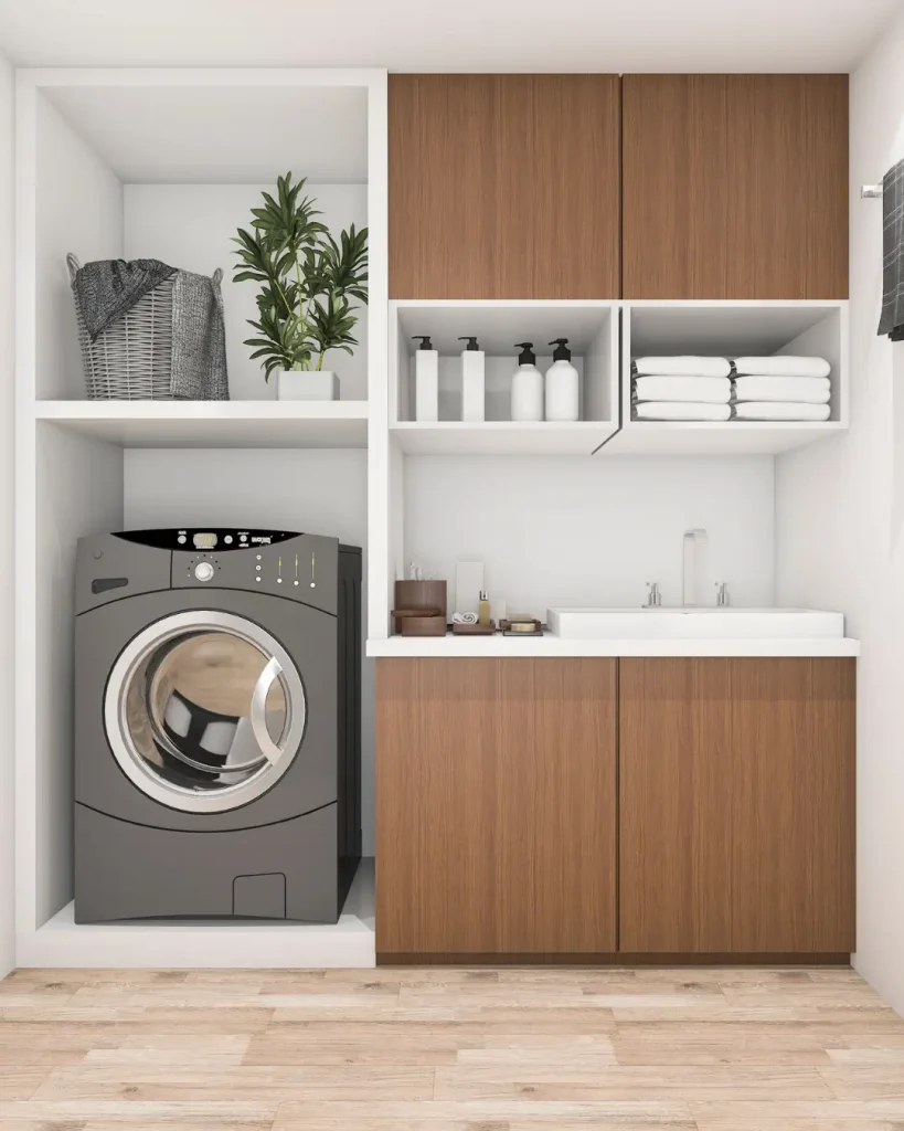 Modern laundry with built-in washer, timber cabinetry, open shelving, and utility sink.