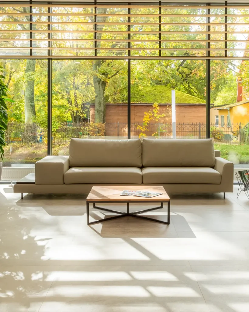 Modern second living room extension with floor-to-ceiling windows and views of a lush garden.