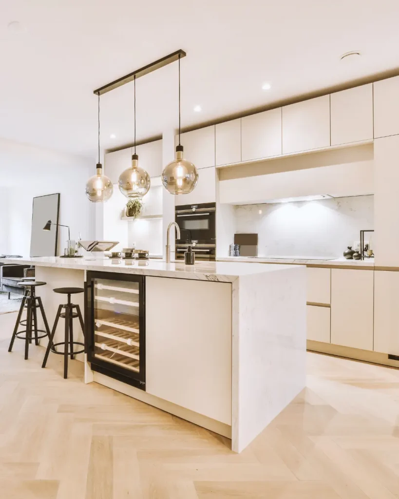 Contemporary open-plan kitchen with island bench, pendant lights, and integrated appliances.
