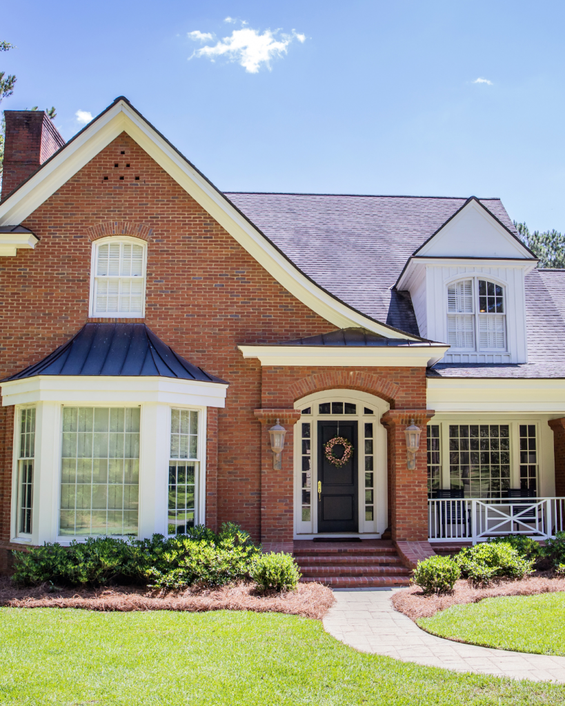 Brick dual-income home in Melbourne with classic design, large windows, and private front entry.