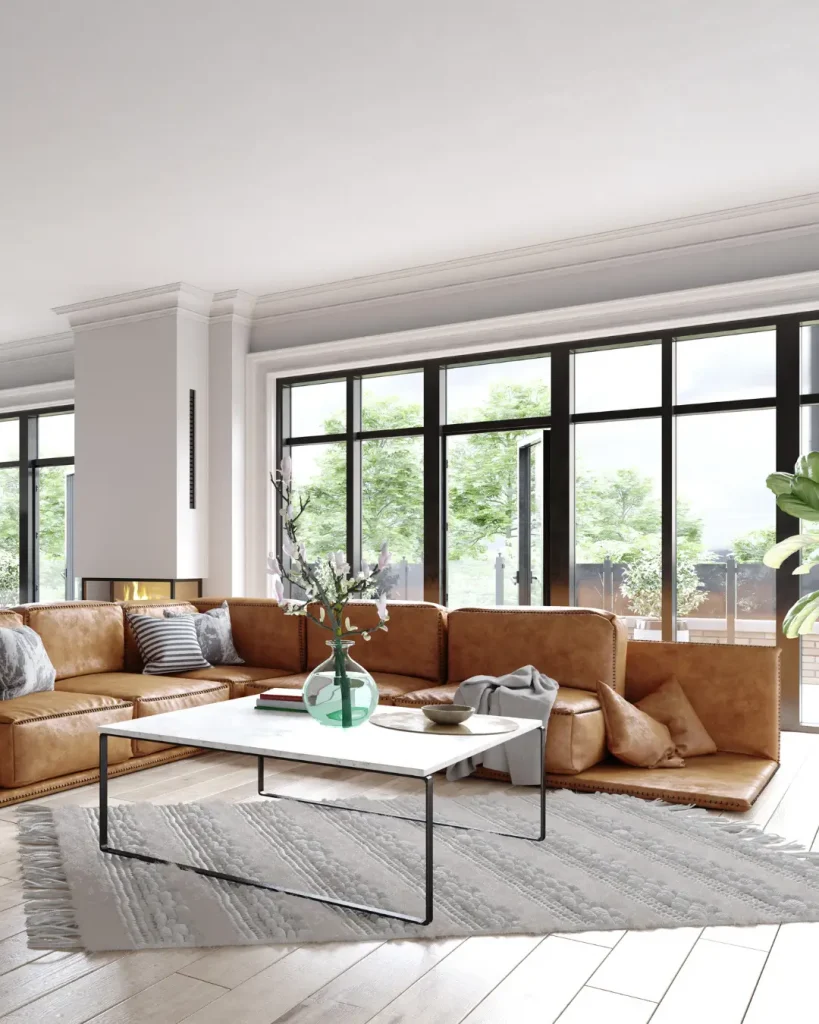 Elegant living space with leather sectional, floor-to-ceiling windows, and minimalist decor.