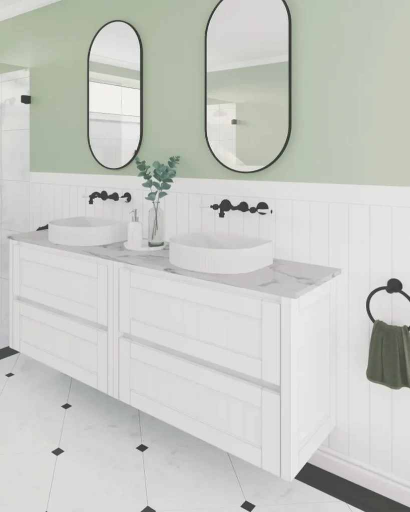 Double vanity with marble top, vertical mirrors, and soft green feature wall in a fresh and modern layout.