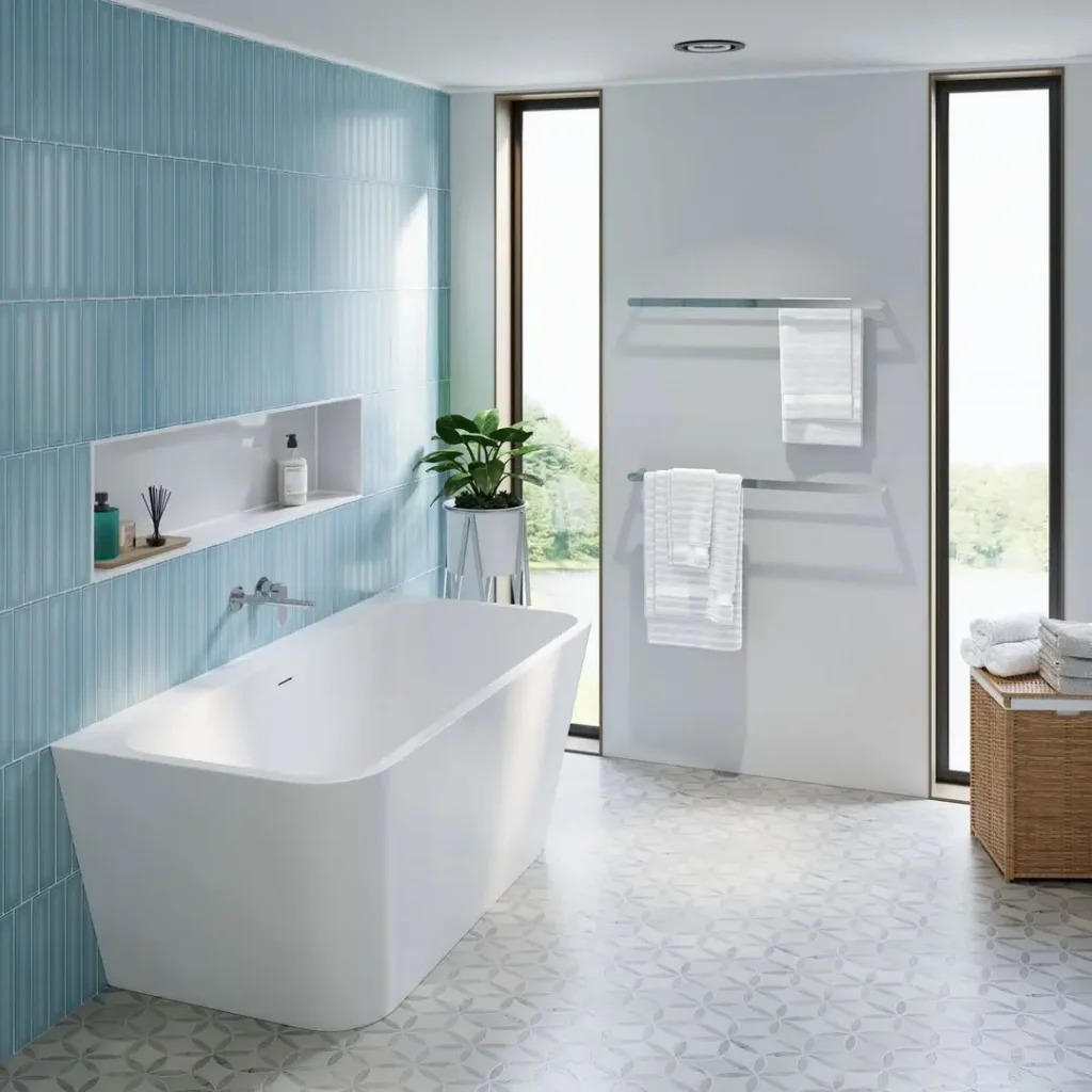 Contemporary freestanding bath with blue vertical tiles and floor-to-ceiling windows in a light-filled space