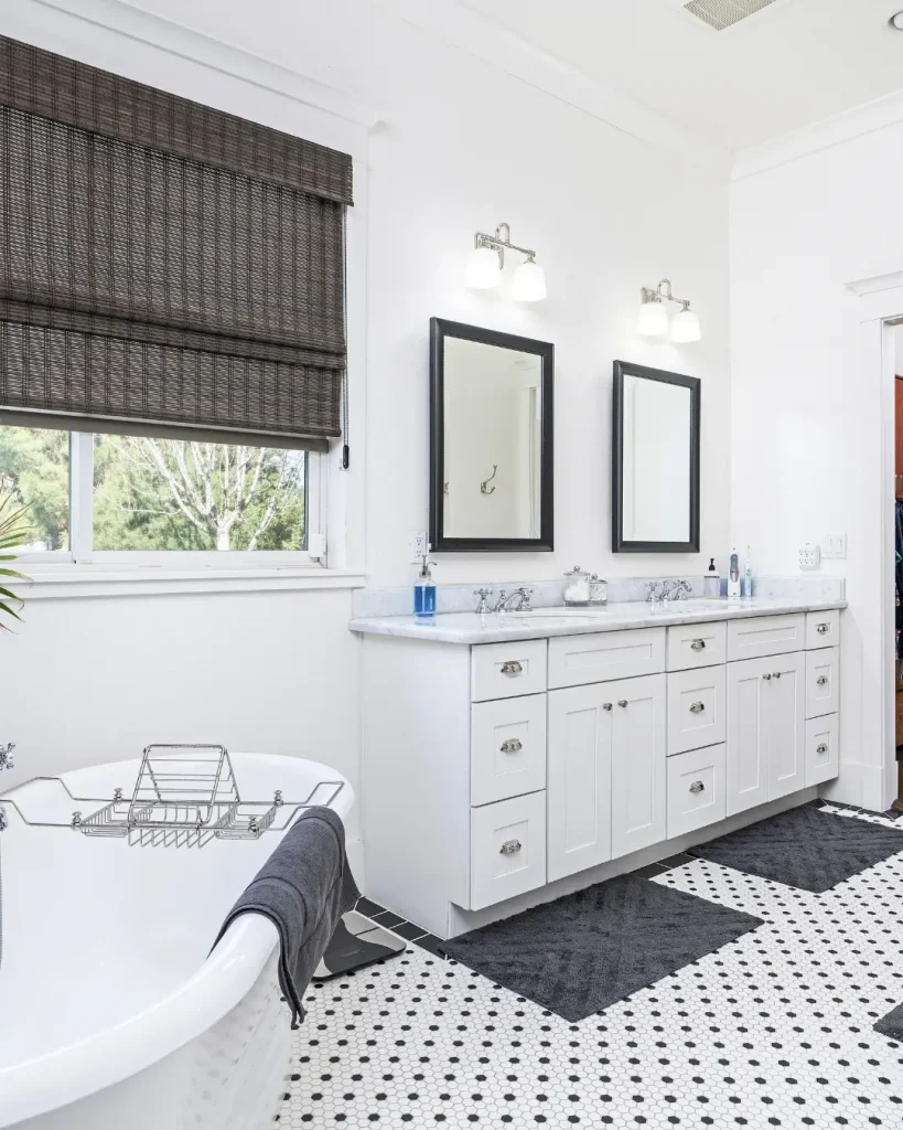 Traditional white bathroom with freestanding tub and double vanity.