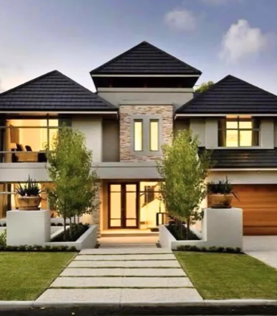 A modern two-story dual-income home with sleek architecture, large windows, landscaped garden, and warm evening lights.