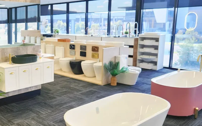 Bright bathroom showroom with freestanding bathtubs, designer toilets, vanities, and tapware on display.