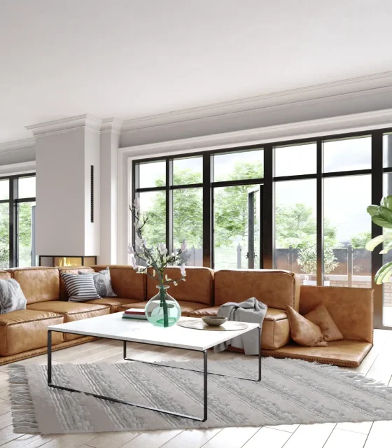 Elegant living space with leather sectional, floor-to-ceiling windows, and minimalist decor.